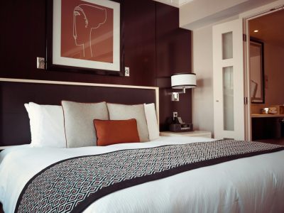 Cozy and modern hotel bedroom interior with elegant decor and soft lighting.
